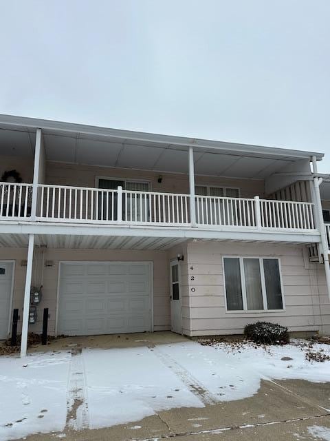 view of front of property with a balcony and a garage