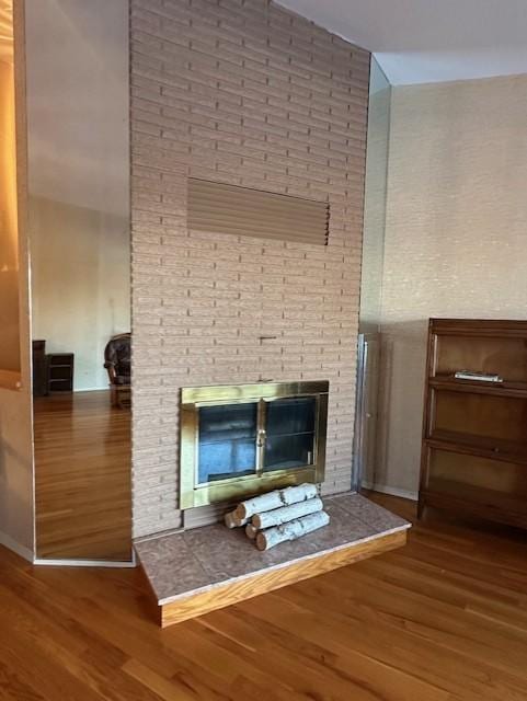 interior details with hardwood / wood-style floors and a fireplace