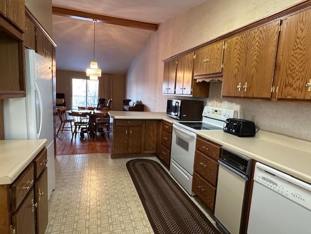 kitchen with kitchen peninsula, dark hardwood / wood-style flooring, white appliances, lofted ceiling with beams, and decorative light fixtures