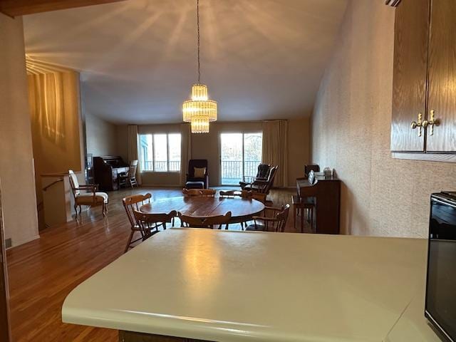 kitchen featuring hardwood / wood-style flooring, pendant lighting, and a chandelier