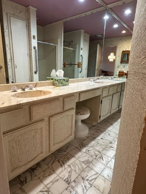 bathroom featuring vanity and a shower with shower door