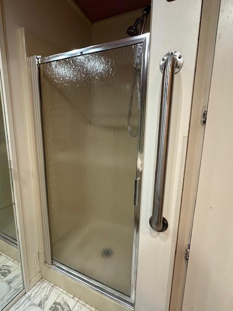 bathroom with a shower with door