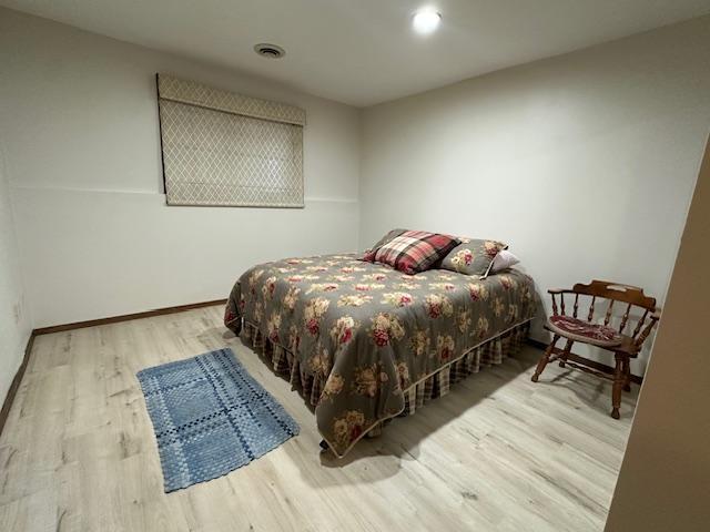 bedroom with light hardwood / wood-style flooring