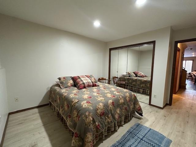 bedroom with a closet and light hardwood / wood-style flooring