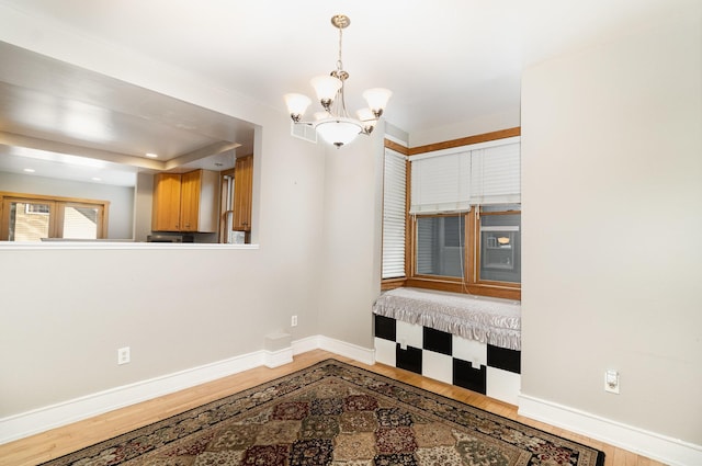 empty room featuring hardwood / wood-style flooring and a notable chandelier