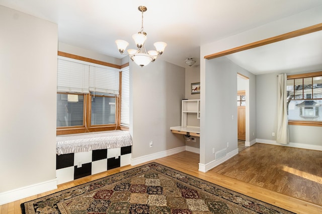 interior space with hardwood / wood-style flooring and a notable chandelier