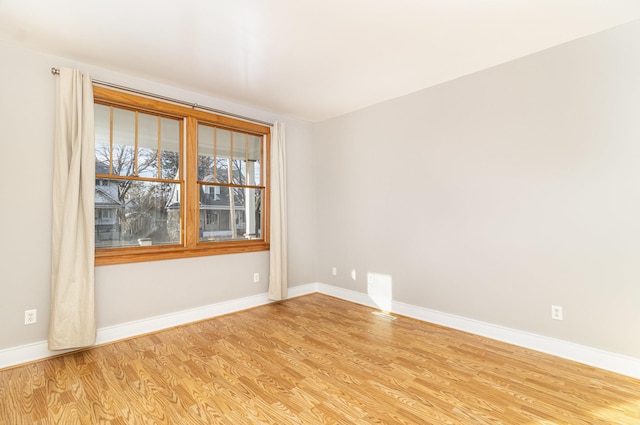 unfurnished room with light wood-type flooring