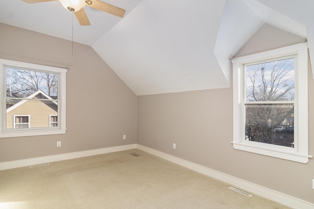 additional living space with carpet flooring, vaulted ceiling, and a wealth of natural light