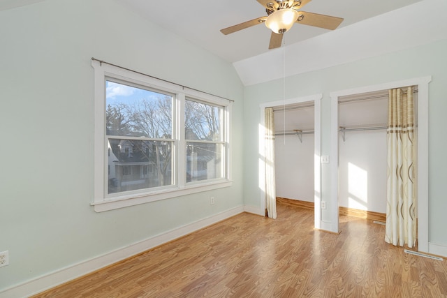 unfurnished bedroom featuring ceiling fan, a closet, light hardwood / wood-style floors, and lofted ceiling