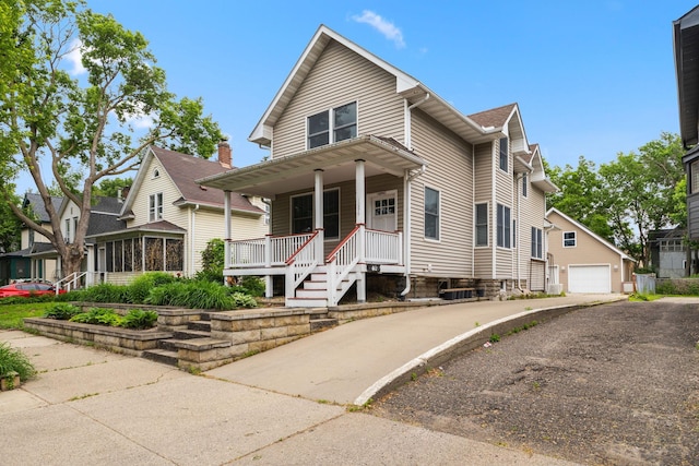 1096 14th Ave SE, Minneapolis, MN 55414 - view of front of property featuring covered porch, a garage, and an outdoor structure