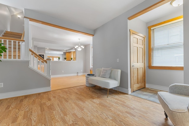 1096 14th Ave SE, Minneapolis, MN 55414 - sitting room featuring stairs, a chandelier, wood finished floors, and plenty of natural light