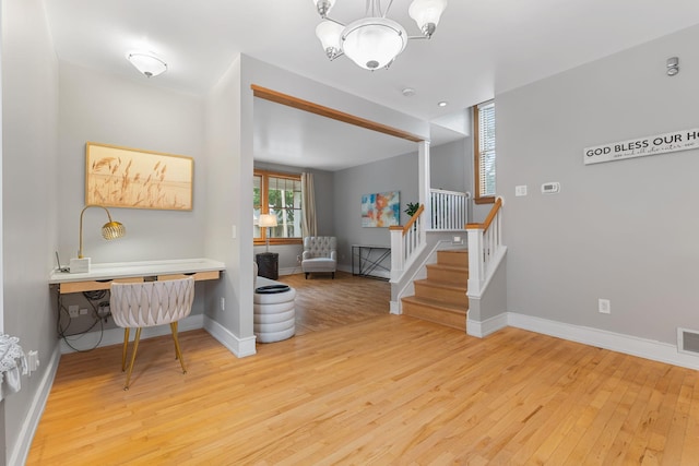 1096 14th Ave SE, Minneapolis, MN 55414 - entrance foyer with light wood-style flooring, stairs, and a chandelier