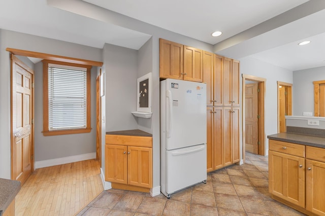 1096 14th Ave SE, Minneapolis, MN 55414 - kitchen with freestanding refrigerator, dark countertops, and recessed lighting