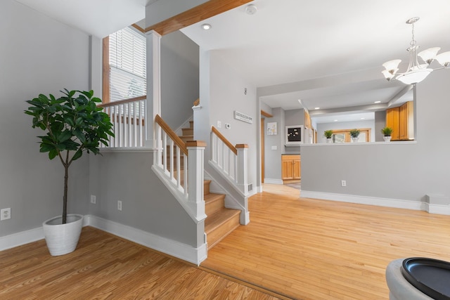 1096 14th Ave SE, Minneapolis, MN 55414 - stairs featuring wood finished floors, a chandelier, and recessed lighting