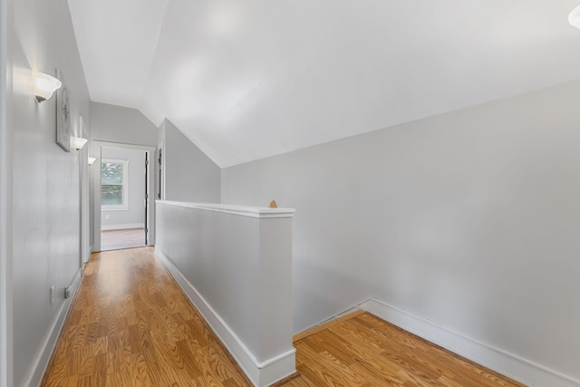 1096 14th Ave SE, Minneapolis, MN 55414 - hallway with light wood-type flooring, an upstairs landing, and vaulted ceiling