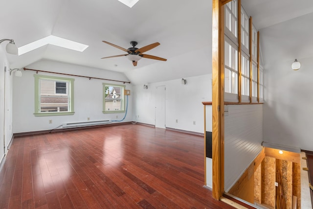 1096 14th Ave SE, Minneapolis, MN 55414 - spare room featuring a skylight, baseboard heating, vaulted ceiling, ceiling fan, and wood-type flooring