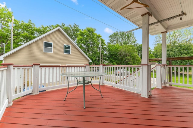 1096 14th Ave SE, Minneapolis, MN 55414 - wooden deck with outdoor dining area and view of scattered trees