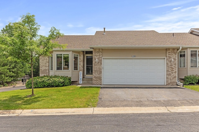 single story home with a front yard and a garage