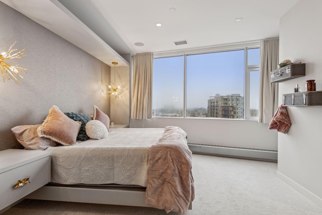 carpeted bedroom featuring baseboard heating