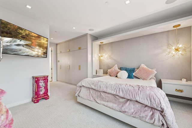 bedroom featuring a chandelier and light carpet