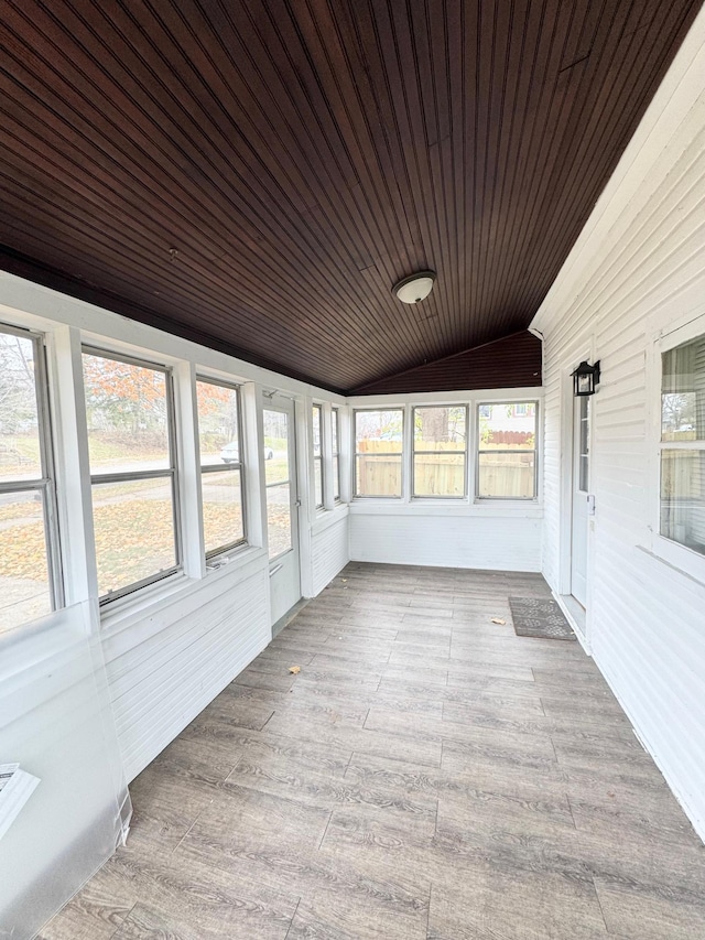 unfurnished sunroom with a healthy amount of sunlight, lofted ceiling, and wooden ceiling