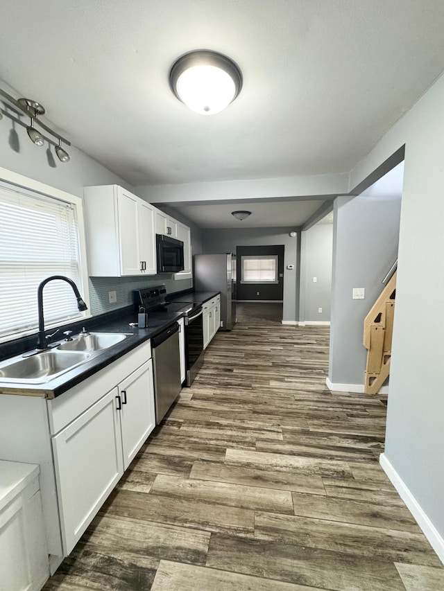 kitchen featuring sink, white cabinets, stainless steel appliances, and dark hardwood / wood-style floors