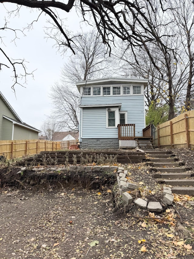 back of property featuring a wooden deck