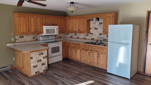 kitchen featuring white appliances, dark hardwood / wood-style floors, and sink