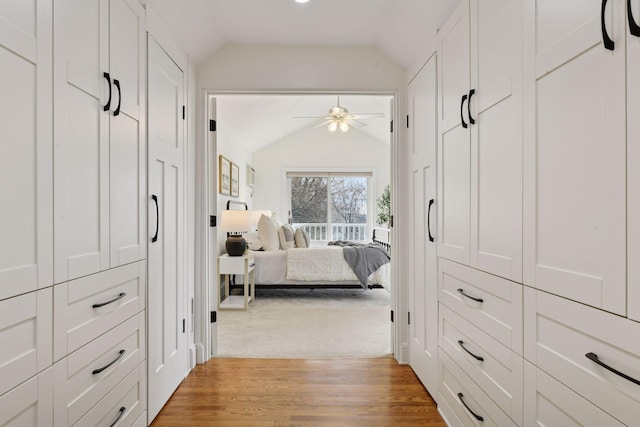 bedroom with vaulted ceiling and light wood-style flooring