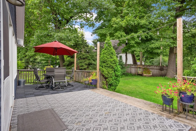 view of patio / terrace featuring outdoor dining space, a wooden deck, and fence