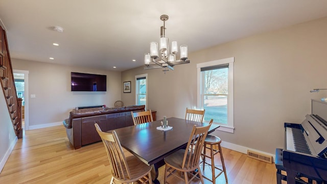 dining room featuring a chandelier and light hardwood / wood-style floors