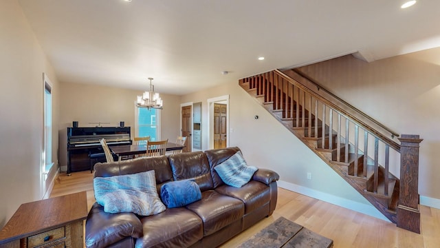 living room featuring light hardwood / wood-style flooring and a notable chandelier