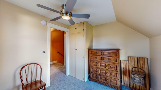 sitting room featuring light carpet, vaulted ceiling, and ceiling fan