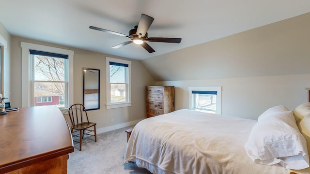 bedroom with ceiling fan, lofted ceiling, light carpet, and multiple windows