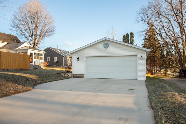 view of front of home with a front yard, an outdoor structure, and a garage