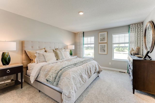 carpeted bedroom featuring a textured ceiling