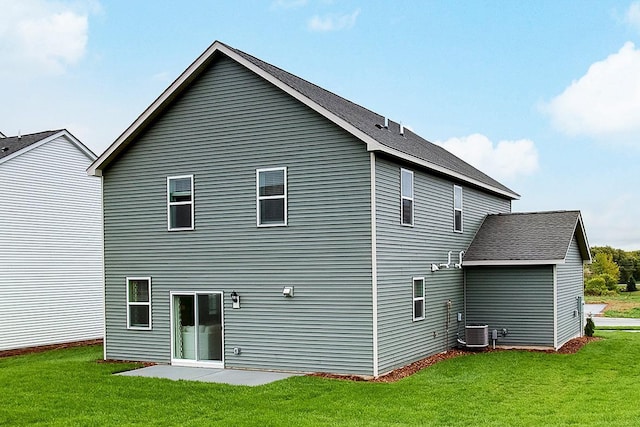 back of property with cooling unit, a patio area, and a yard