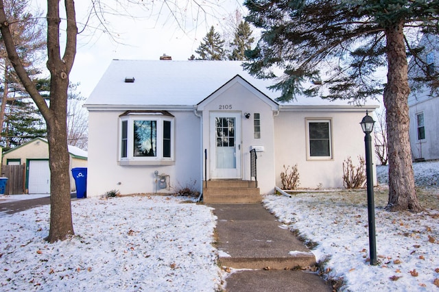 bungalow-style home with an outbuilding and a garage