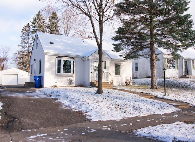 view of front facade with an outbuilding and a garage