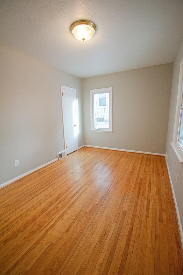 unfurnished room featuring light hardwood / wood-style flooring