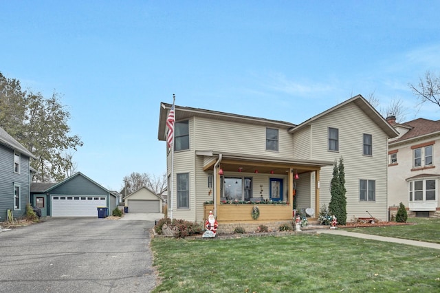 view of property with a porch, a front lawn, an outdoor structure, and a garage