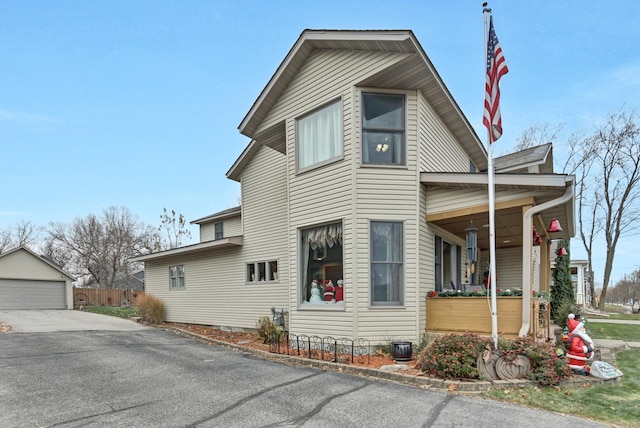 view of side of property with an outdoor structure and a garage