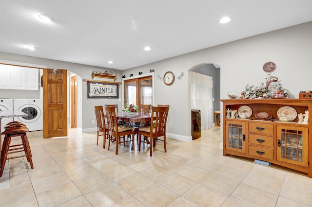 tiled dining space with washing machine and dryer