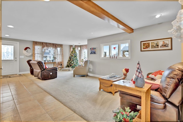 living room featuring a wealth of natural light, beamed ceiling, and light tile patterned floors