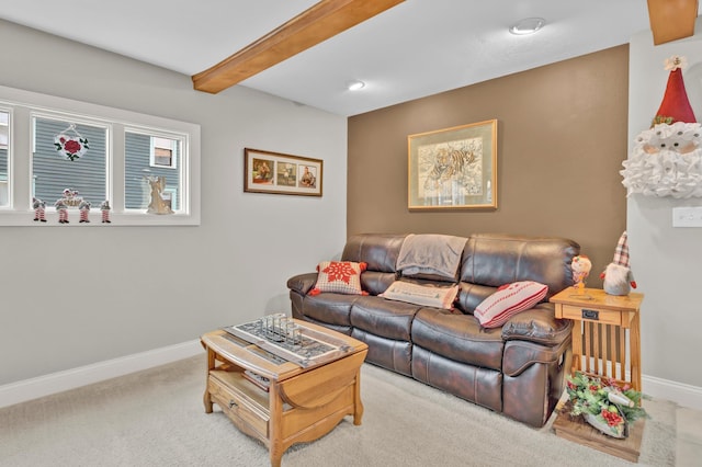 living room with beamed ceiling and light carpet