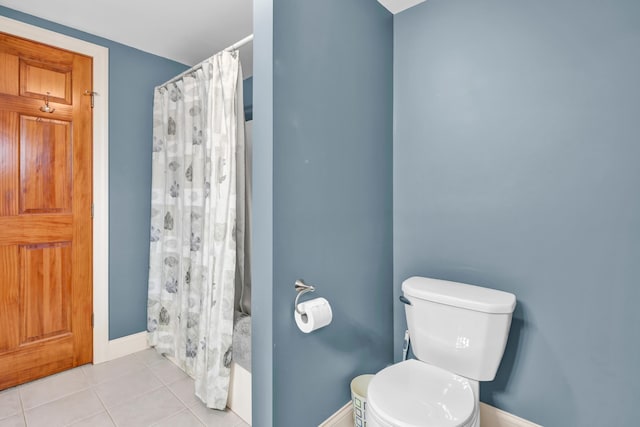 bathroom featuring tile patterned flooring, toilet, and a shower with shower curtain