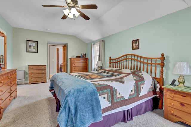 carpeted bedroom with vaulted ceiling and ceiling fan