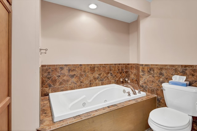 bathroom featuring a relaxing tiled tub and toilet