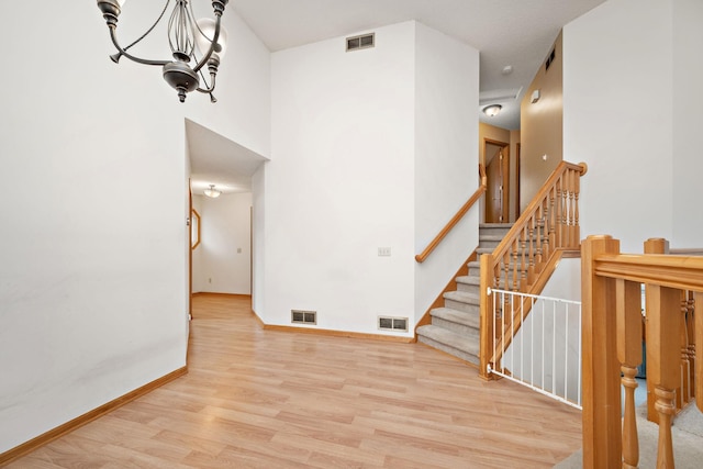 interior space featuring an inviting chandelier and light hardwood / wood-style flooring