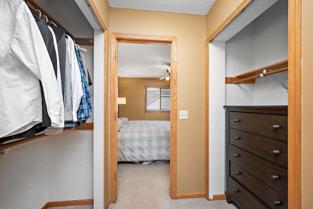 walk in closet featuring ceiling fan and light colored carpet